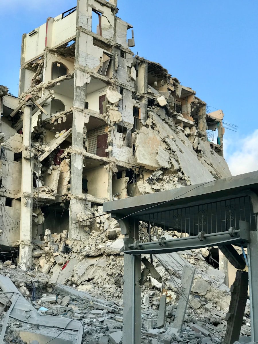 Photo by Emad El Byed A very large building that has a bunch of rubble on it